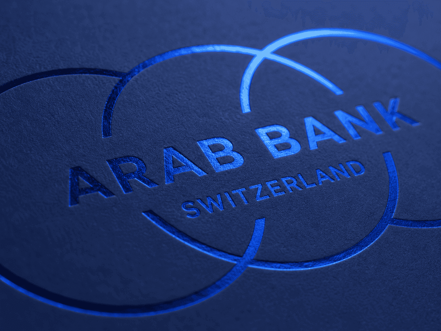 The Arab Bank Switzerland logo in blue foil on a deep navy cover