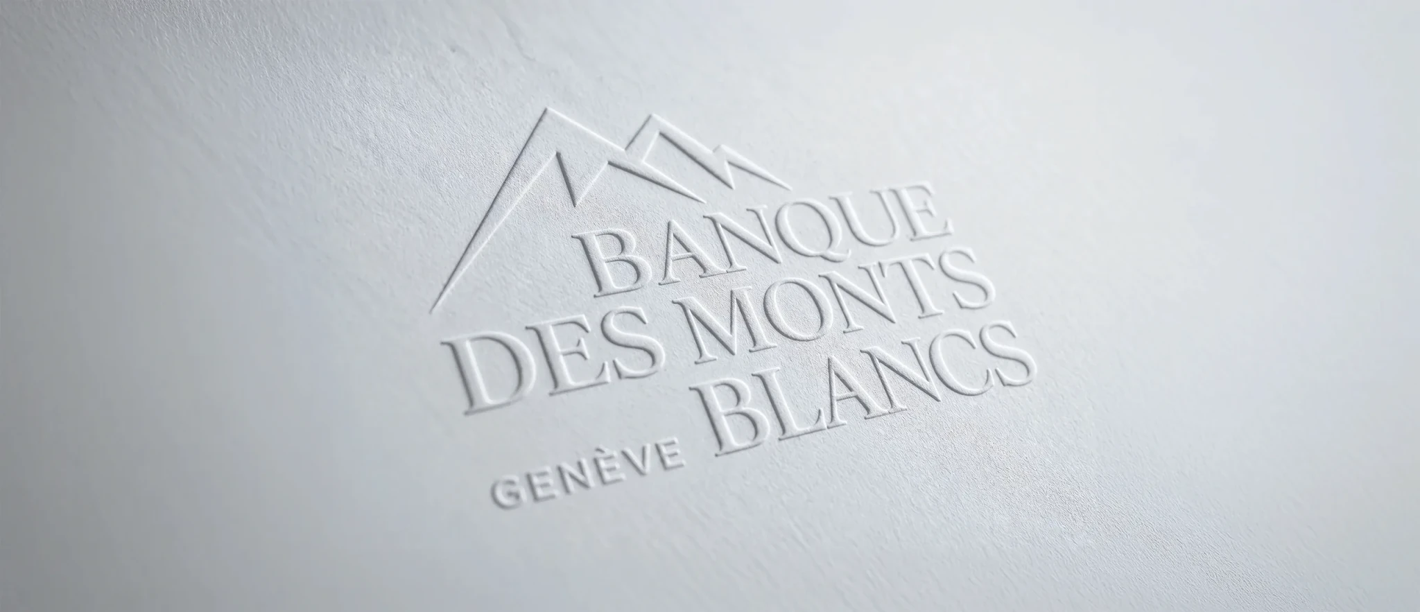 The Banque des Monts Blancs logo blind-embossed into white paper